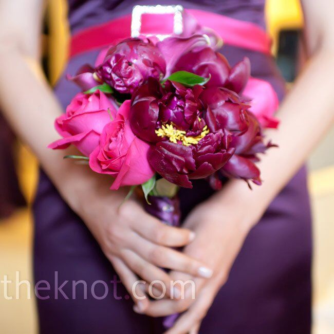 Deep pink and purple roses and peonies coordinated with the maid of honor’s dress and belt.