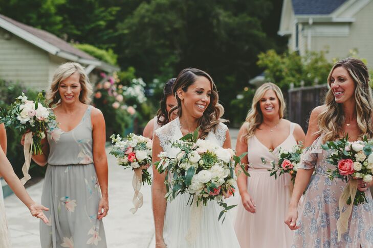 Amanda Connors from florist Design in Bloom paired white and blush garden roses with greenery for Crystal and her bridesmaids, who wore dresses in varying shades of blush, gray and ivory.