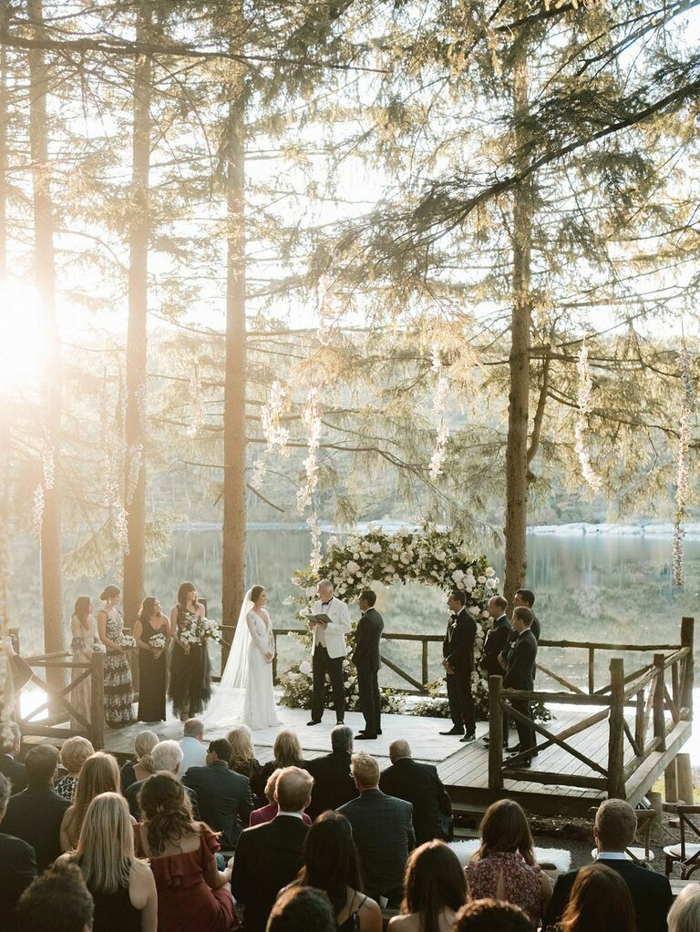 Elegant waterfront vow ceremony at outdoor summer wedding