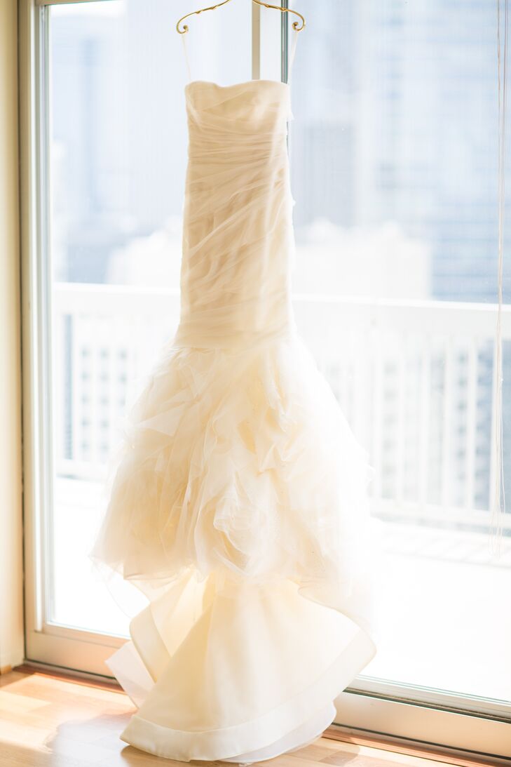For her walk down the aisle, Emily donned an ivory Vera Wang design that incorporated French tulle and silk organza. "We wanted our attire to feel timeless and classic in order to match the formality of our black-tie-optional wedding," she says.