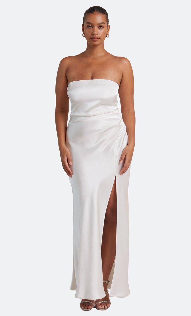 Model wears a white silk strapless gown. 