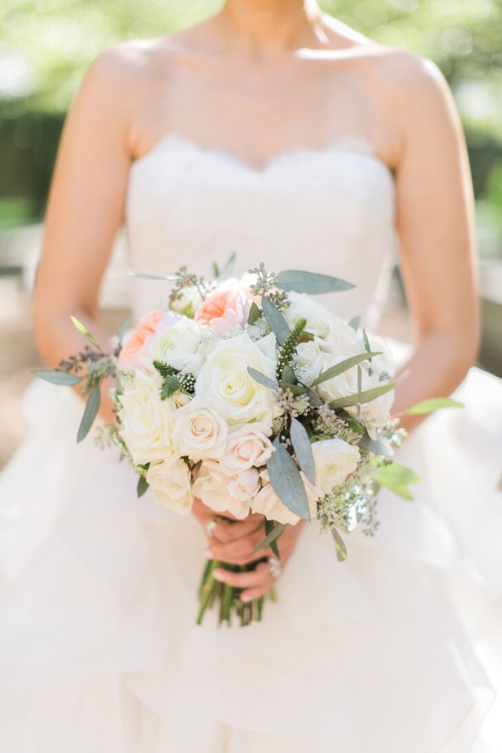 Jessica carried a white and pastel pink rose and garden rose bouquet, offset by eucalyptus leaves.