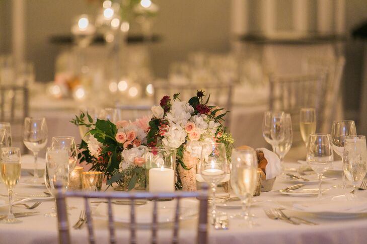 A low arrangement pink roses, white hydrangea and assorted greens decorated the tables. A ring of candles around the floral arrangement added a sophisticated, romantic touch.