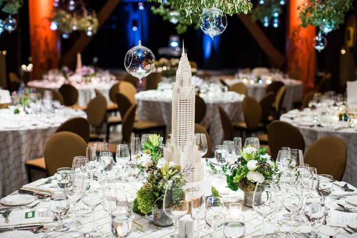 Michelle and Ryan created origami architectural buildings that served dining table centerpieces and markers for guests to find their seats. They had to figure out which centerpiece building they were assigned to through the three facts written on their escort cards.