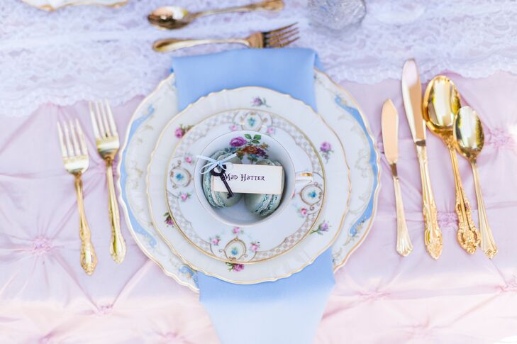 The dinnerware on reception tables were labeled with Alice in Wonderland characters, which matched escort cards that led guests to their assigned seating arrangements.