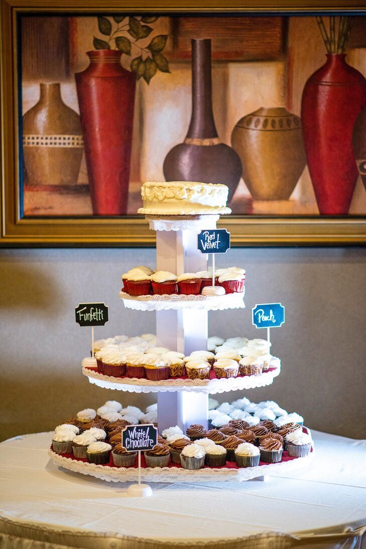 A friend of the bride and groom offered to bake the cutting cake and a cupcake tower with red velvet, funfetti, peach, and white chocolate flavored treats. Leah says, "Planning our wedding wasn't difficult, and it was amazing how close it brought us with everyone. We had so many people come to us and say, 'I can bake,' 'I can sew,' 'I can help,' etc."