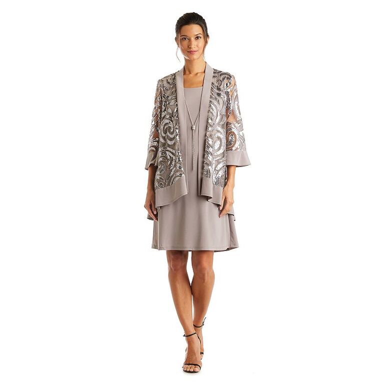 Model wearing a petite dress in champagne with a shimmering matching jacket
