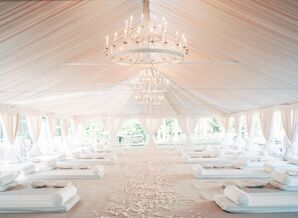 Tented Ceremony Space With White Draping and Chandeliers
