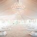 Tented Ceremony Space With White Draping and Chandeliers