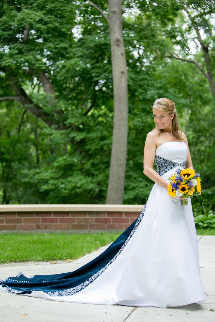 Dawn wore a strapless wedding dress with a navy band around the waist and down the train. "We had already chosen a deep blue for the bridesmaid dresses, so when I saw this dress at Classy Consignments Bridal, it was perfect," Dawn says.