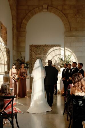 Bride and Father Walk Down the Aisle in Art Museum Ceremony