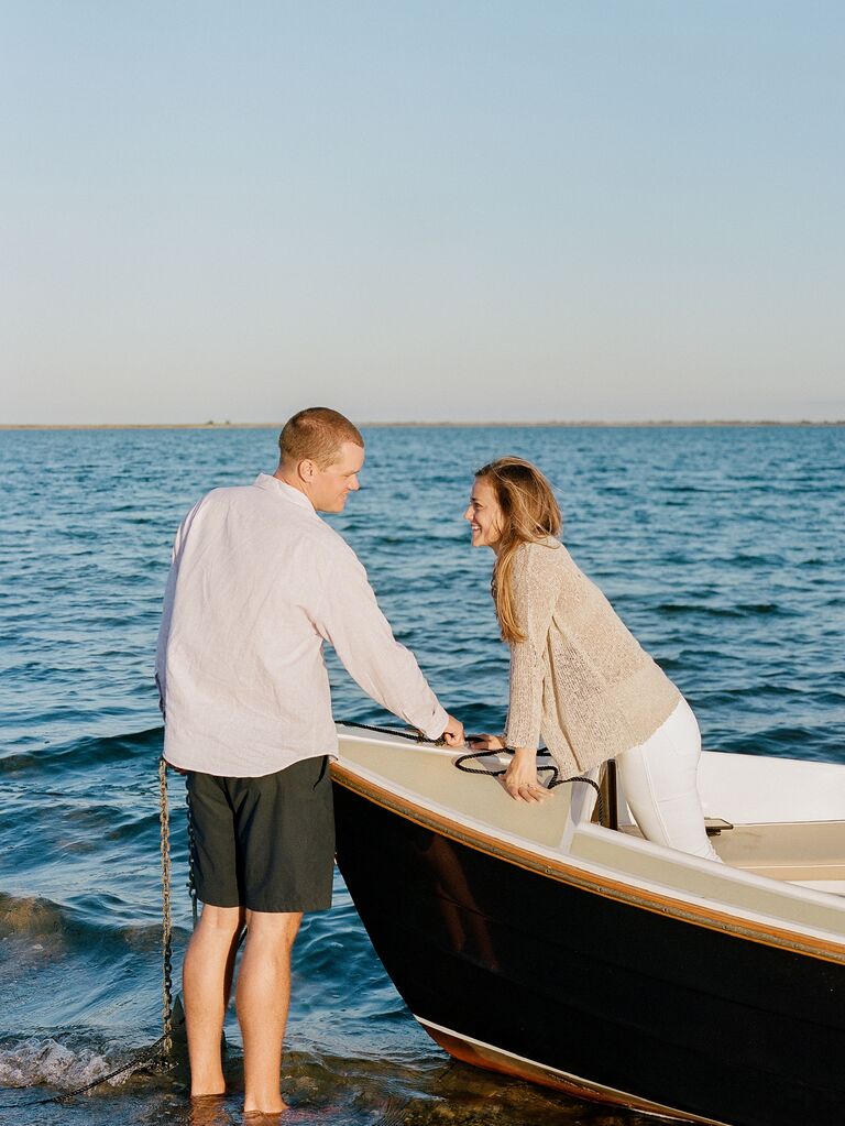 Couple poses on a boat. 