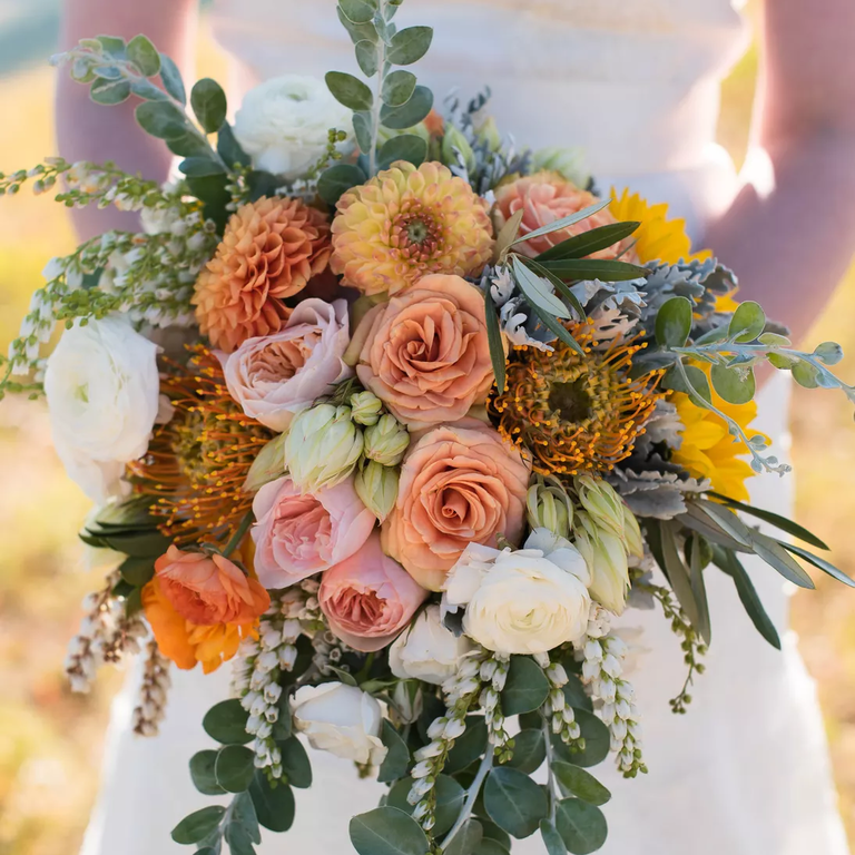Cascading bouquet of protea and roses