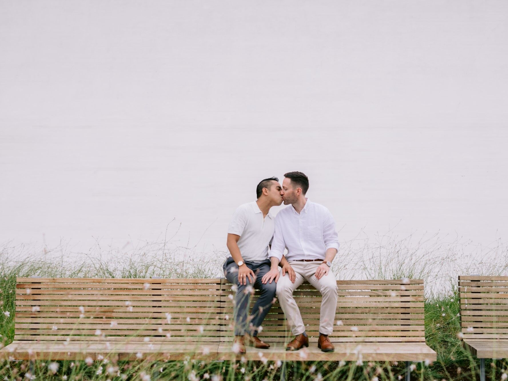 Couple share a sweet kiss at their engagement photo shoot. 