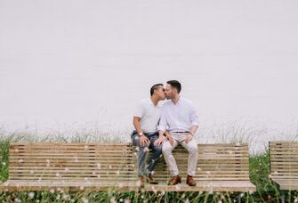 Couple share a sweet kiss at their engagement photo shoot. 