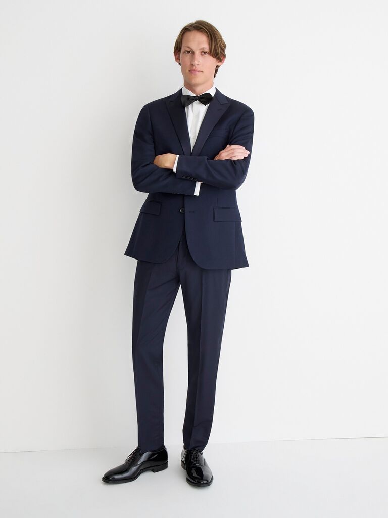 Model wears a navy blue suit by J. Crew. 