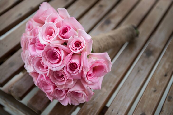 The couple planned to have garden roses but the blooms they ordered online dropped all of their petals on the day of the wedding. "We made an emergency run to Cosco and bought every pink rose they had instead," says Rachel. "Regular pink roses are my favorite flower now—these things happen and you have to roll with it!"