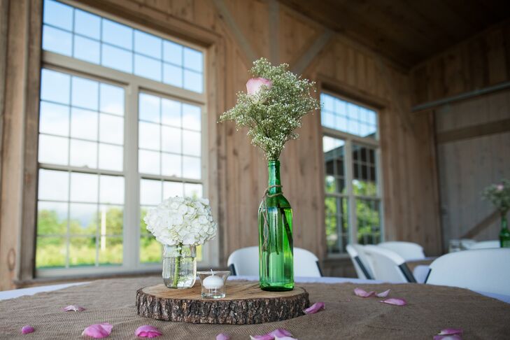 Rachel and Alex reflected their minimalist rustic theme through their simple centerpieces. "We had single roses in green wine bottles, tree stump centerpieces with burlap and single cut hydrangeas in mason jars," says Rachel. "I wanted it to reflect our Southern roots, but still feel outdoorsy and casual."