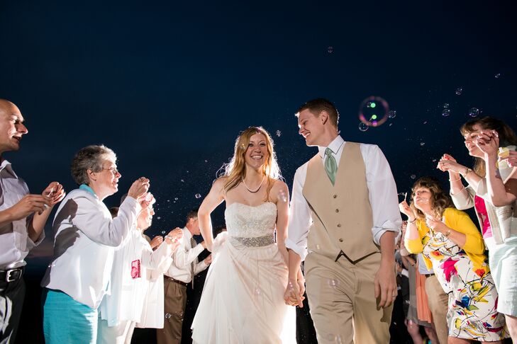 Instead of leaving the wedding at the end with an official send off, Rachel and Alex stayed to say goodbye to each guest as they left. "We were the last to leave and made everyone feel special, which they are!" says Rachel. "Our photographer pointed out that we wouldn't have exit photos, so we staged them! Running through the wet field over and over to take photos, with everyone having a blast, was the best part!"