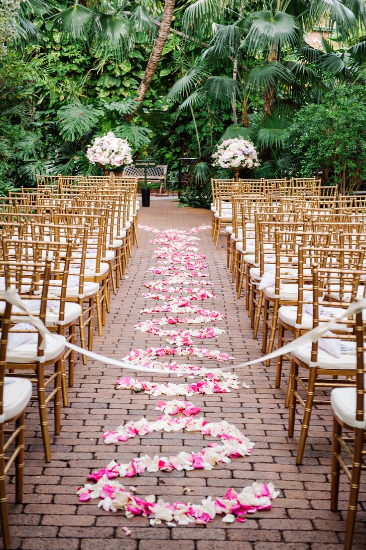 The exposed-brick ceremony aisle was decorated with pink and white rose petals in a scroll pattern for a touch of drama and romance.