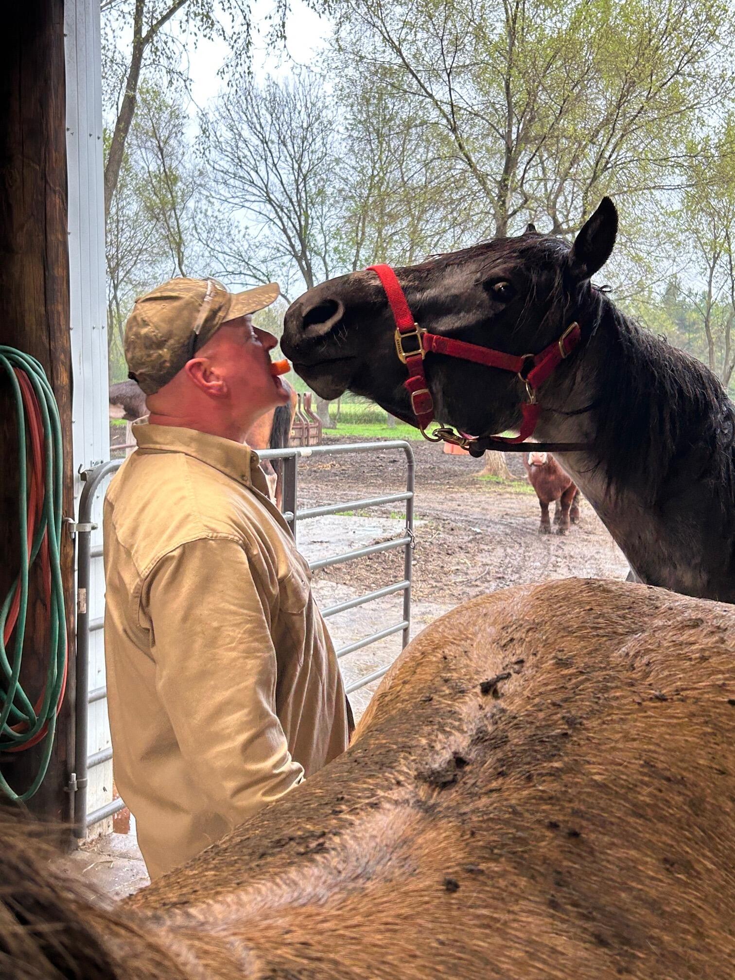 We enjoy doing chores together at the barn. Dan's horse, Legend, is always happy to get a treat any way he can.