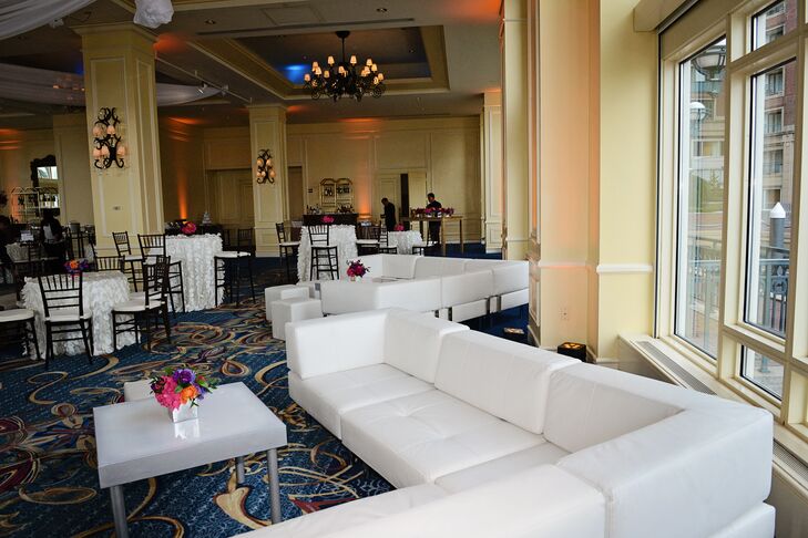 While guests enjoyed cocktail hour in the Boston Harbor Hotel’s waterfront Rotunda, Cort Furniture Rental transitioned the Wharf Room for the reception.  The couple decided against the traditional sit-down style reception for something with a more festive flair that encouraged guests to mix and mingle. Lounge areas with chic modern furnishings and a mix of low and high cocktail tables gave the room a lounge-inspired vibe with bunches of bright blooms infusing the space with energy and life. “We wanted people to feel like they were at a party and not a typical wedding,” says Ashley.