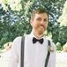 Known for his stellar personal style, Gavin selected a relaxed look complete with a plum bow tie. His grey suspenders boasted a boutonniere of Queen Anne’s Lace and a single rose bloom.