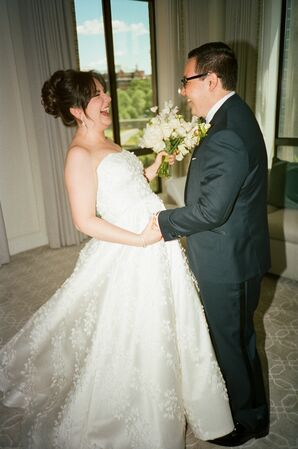 Bride in Sophisticated Updo, White-and-Greenery Bouquet and Groom in Dark Tuxedo, Boutonniere