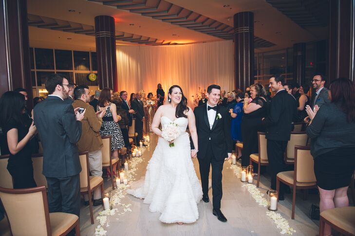 “You are the Best Thing” by Ray LaMontagne filled the room as Pamela and Dan started their recessional. Fleurescent, their florist, extended the couple’s romantic ceremony backdrop with  soft arrangements.Ivory rose petals separated each cylinder vase as soft candelight glowed within it.
