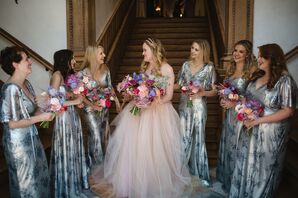 Bride in Blush Wedding Dress Talks With Bridesmaids in Blue Marchesa Dresses