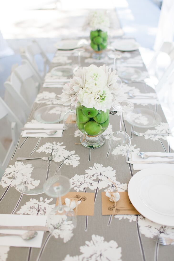 Madison loved the way fresh green apples evoked the green in the floral centerpieces. She placed them in glass vases atop hand-sewn gray table linens on each dining table.