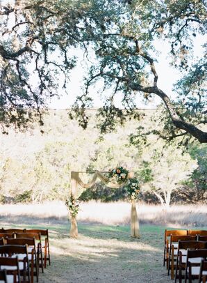 Ceremony Arch with Yellow Draping at The Ivory Oak in Wimberley, Texas