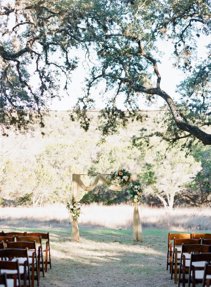 Ceremony Arch with Yellow Draping at The Ivory Oak in Wimberley, Texas