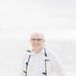 Casual Groom on the Beach With a Lei at His 50th Wedding Anniversary Vow Renewal