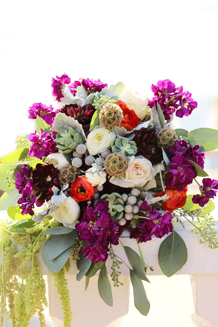 “Our bouquets were everything,” Cassandra says of the brides’ arrangements of purple and red blooms, succulents and cascading amaranthus.
