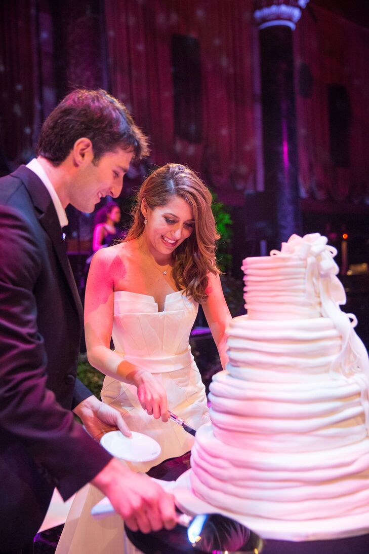 The four-tier white buttercream cake was finished with a large, loose bow on one side.