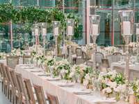 spring wedding tablescape with tall silver candlesticks and low centerpieces with white flowers