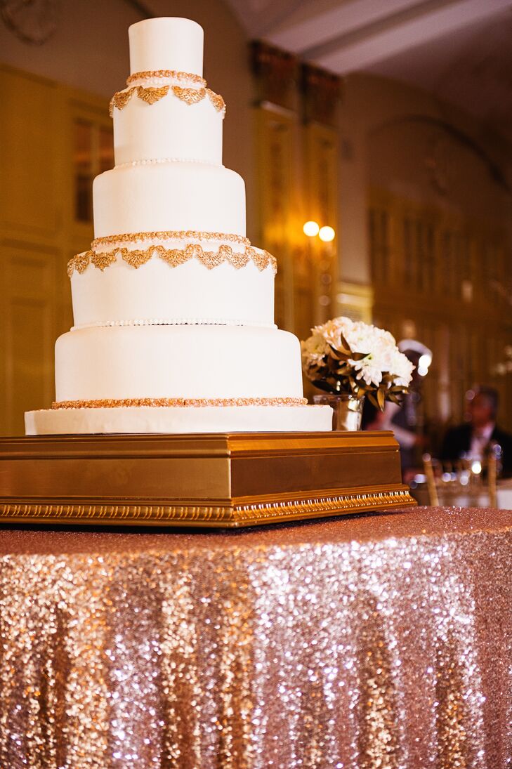 Christine and Keith enjoyed a five-tier white fondant wedding cake decorated with ornate gold detailing. The cake was white cake with hazelnut praline mousse and chocolate cake with caramel mousse. Yum!