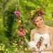 Chelish Moore Flowers created a lush flower crown from bright red roses, green orchids and various types of greenery for the bride. Paired with her loose, romantic updo, the crown added a bohemian touch to her look.