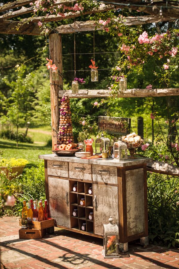 Vintage furniture provided the base for displaying an array of playful desserts, like a donut tower and biscuit bar by Two Guys N A Kitchen.