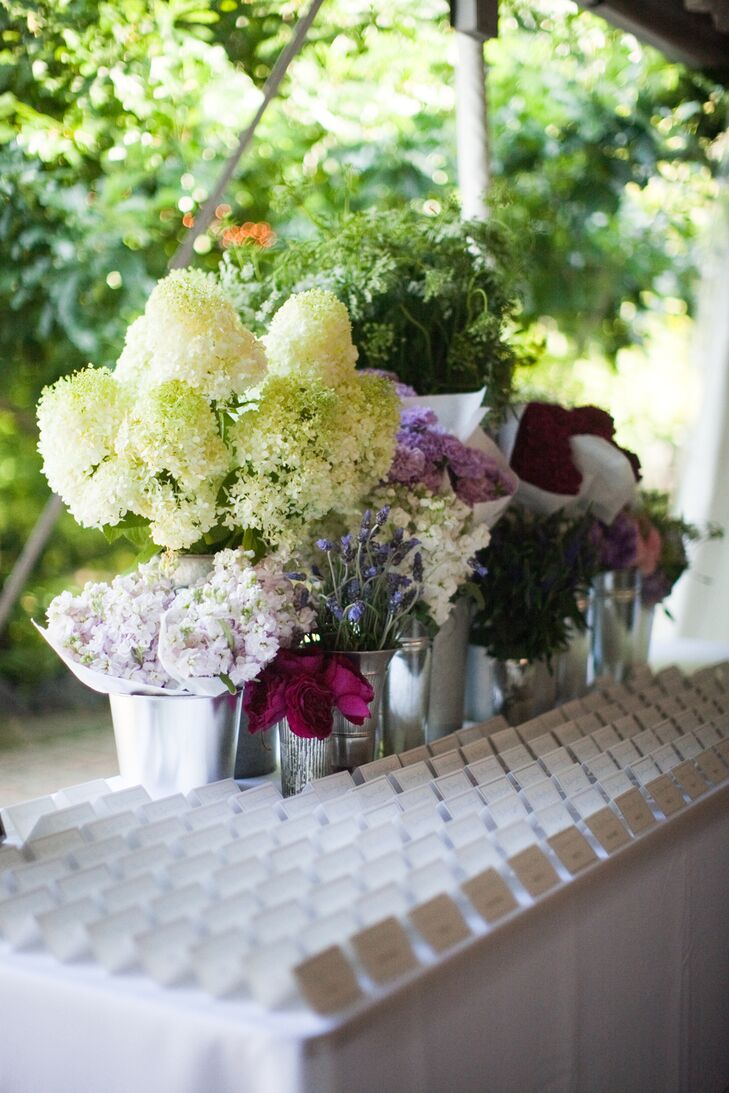 Various flower bouquets decorated the place card table creating the look of a French flower cart.