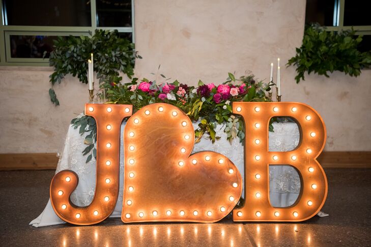 A custom made sign with Jenna's and Brett's initials faced the dance floor at the indoor reception at Springs Preserve in Las Vegas, Nevada.
