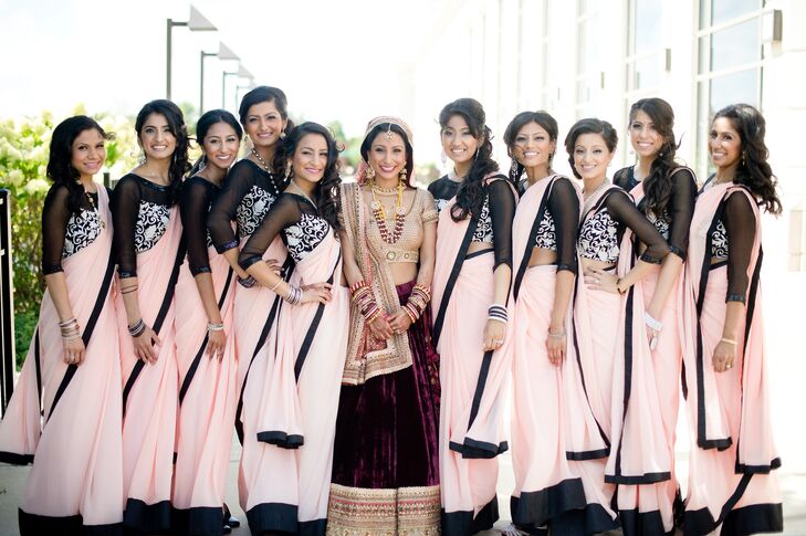 Megha custom-designed her bridesmaids’ saris during her trip to India, drawing inspiration from some of her favorite designers. The saris were constructed from airy chiffon fabric in a light blush color that allowed the girls to move around comfortably, while complementing the wedding’s ethereal, romantic theme. The blouse piece featured sheer black fabric and was embroidered with an elegant white floral pattern. Shimmery accents on the neckline and sleeves added a subtle glam touch.