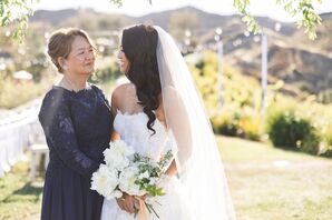 Bride With Veil Hugging Mother of the Bride in Navy Dress