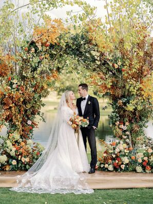Bride and Groom Portraits Beside Rustic Arch With Leaves