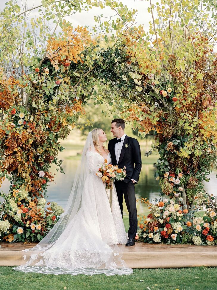 Bride and Groom Portraits Beside Rustic Arch With Leaves