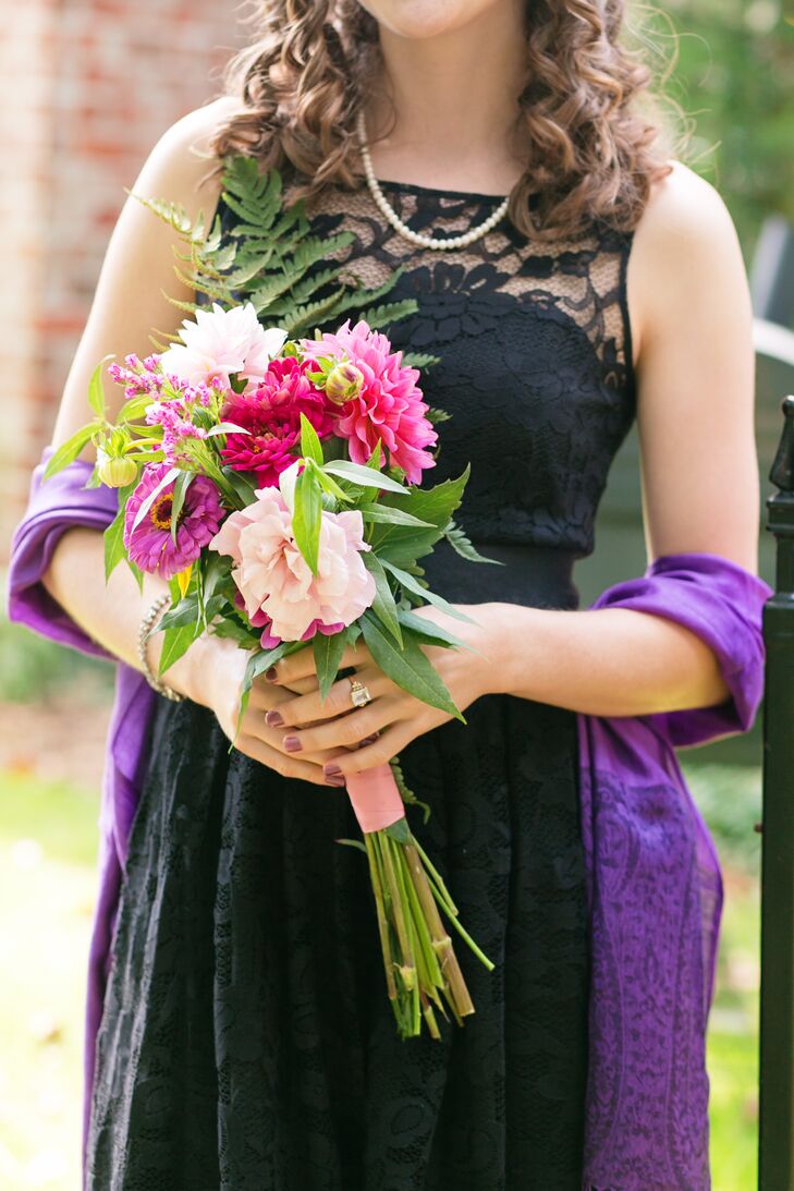 The bride and groom enhanced their black, pink and purple color palette with local fresh flower arrangements made by family friends.