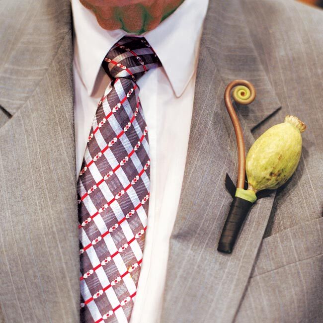 The groomsmen wore poppy pods accented with fiddlehead fern on the lapels of their suits.