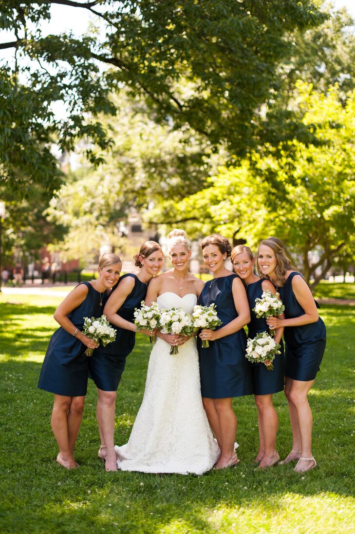 Maggie's five bridesmaids donned sophisticated navy blue dresses with open backs. They also wore different necklaces from designer Erin McDermott.
