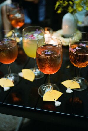 Colorful Cocktails With Live Flowers and Drink Charms Featuring Delicate Yellow Fans